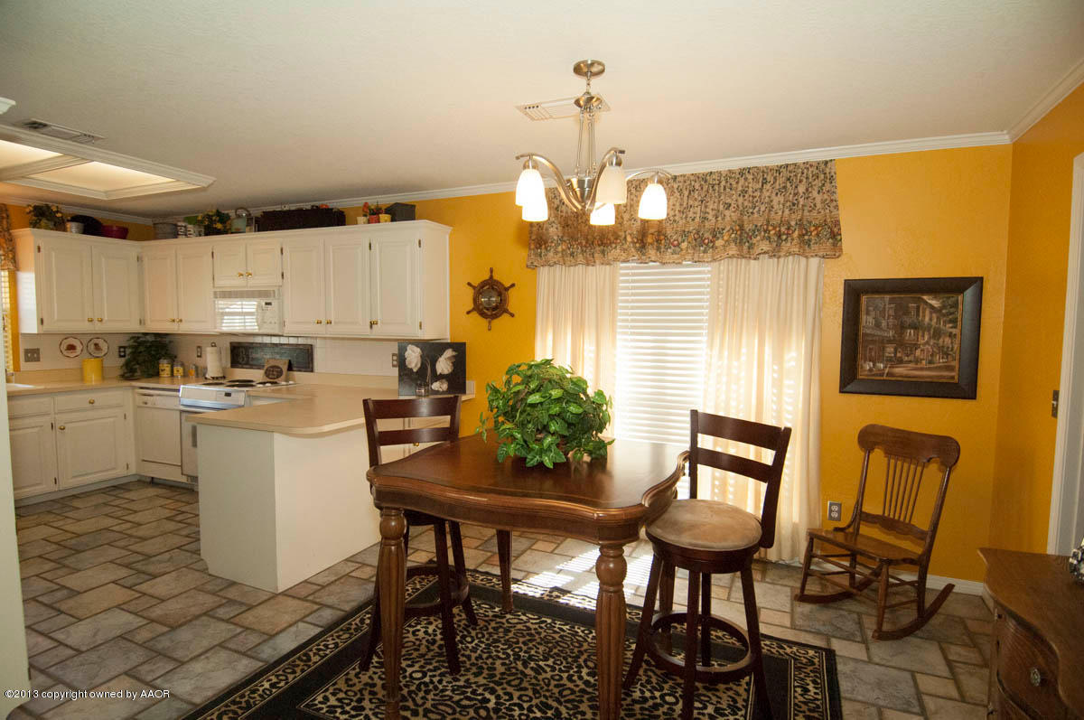 5402 Leo Lane Amarillo, TX 79110 - Photo 14 of 37 a kitchen with a dining table chairs and refrigerator