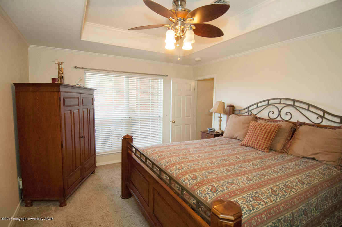 5402 Leo Lane Amarillo, TX 79110 - Photo 17 of 37 a bedroom with a bed and a window