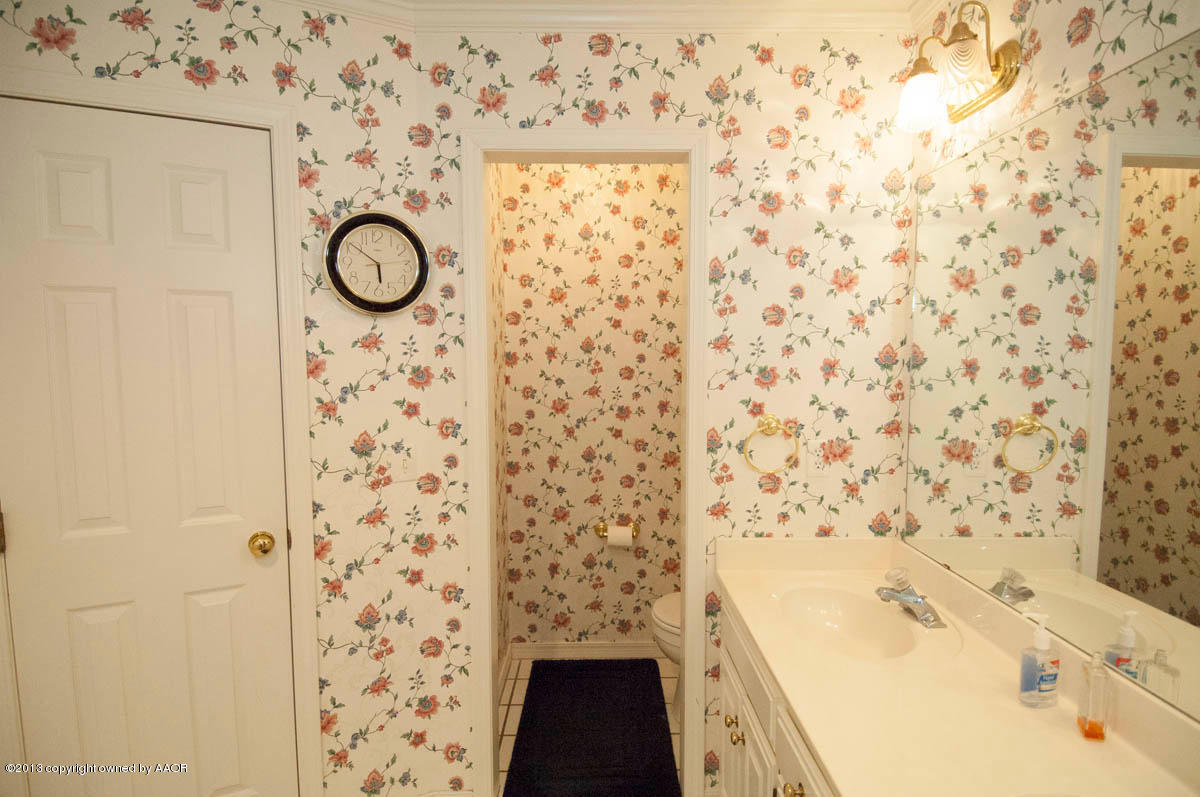 5402 Leo Lane Amarillo, TX 79110 - Photo 20 of 37 a bathroom with a shower curtain and a sink