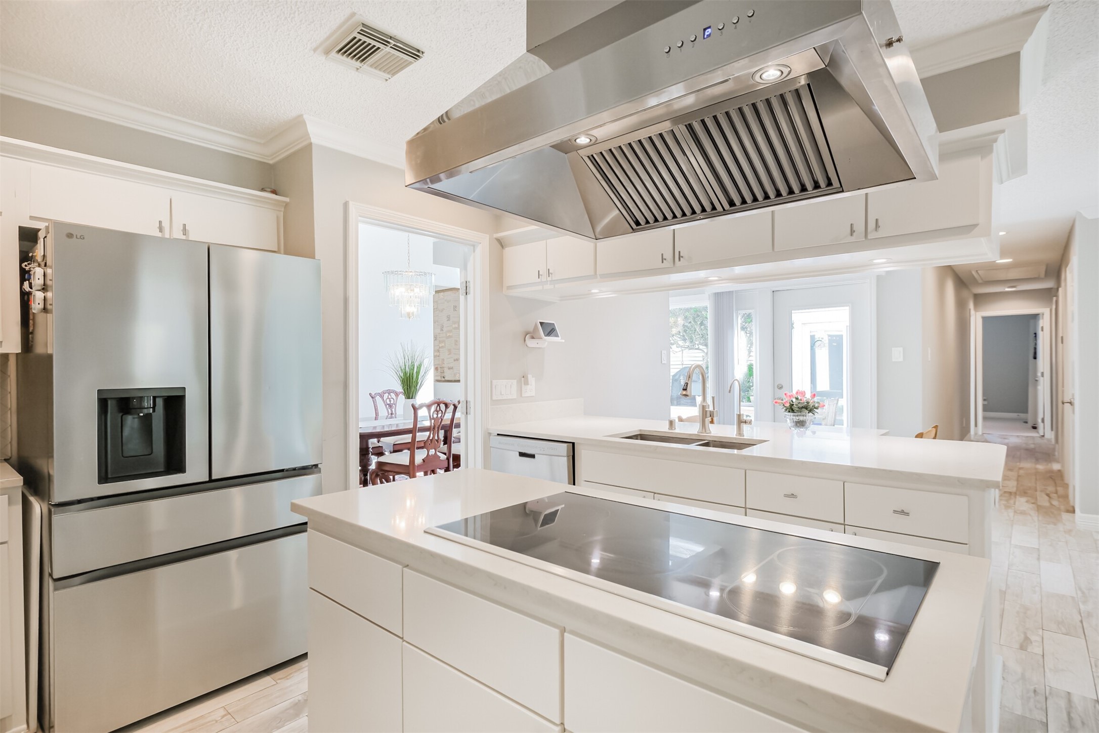 1007 Arrow Hill Road Houston, TX 77077 - Photo 14 of 48 The electric cooktop with stainless steel vent hood is a quick way to whip up a meal! There is also a LG refrigerator that is included with the sale.