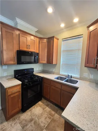 a kitchen with stainless steel appliances granite countertop a sink stove and microwave