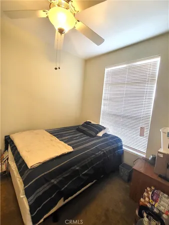 a bedroom with a bed dresser and a window