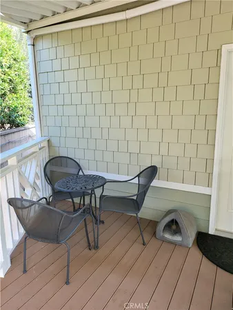 a view of a chairs and table in the balcony