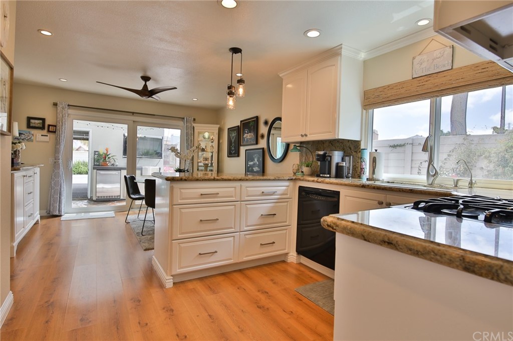 38 Racing Wind Irvine, CA 92614 - Photo 11 of 56 a large kitchen with stainless steel appliances a large counter top a stove a chimney a sink and a large window