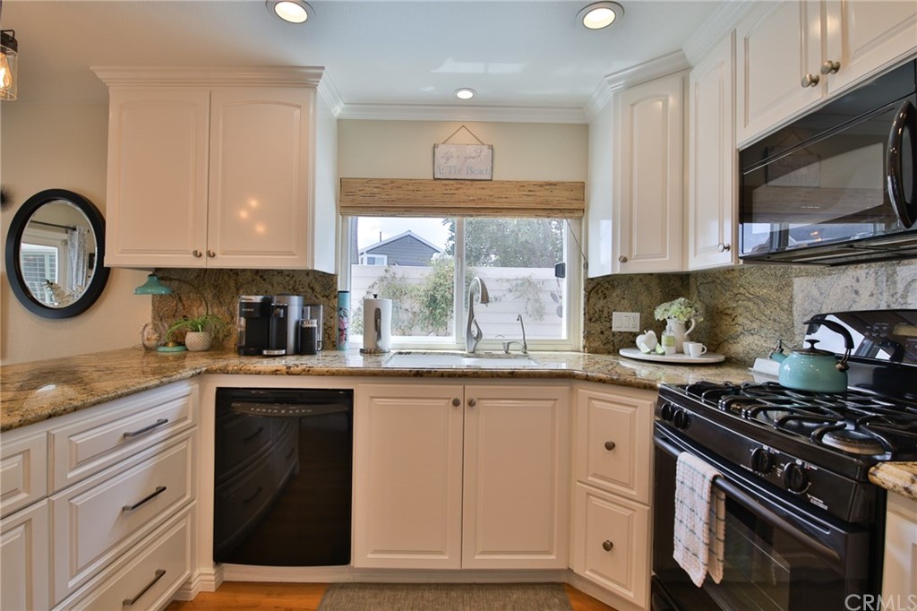 38 Racing Wind Irvine, CA 92614 - Photo 12 of 56 a kitchen with cabinets appliances and a window
