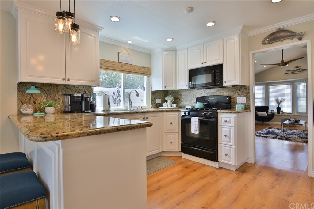 38 Racing Wind Irvine, CA 92614 - Photo 13 of 56 a kitchen with stainless steel appliances granite countertop a sink a stove and a refrigerator