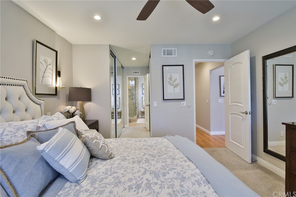 38 Racing Wind Irvine, CA 92614 - Photo 16 of 56 a bedroom with a large bed and a chandelier