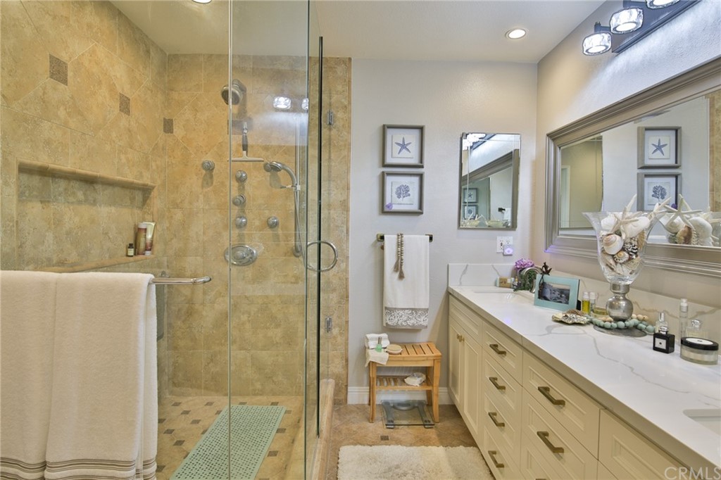 38 Racing Wind Irvine, CA 92614 - Photo 21 of 56 a bathroom with a double vanity sink mirror and shower
