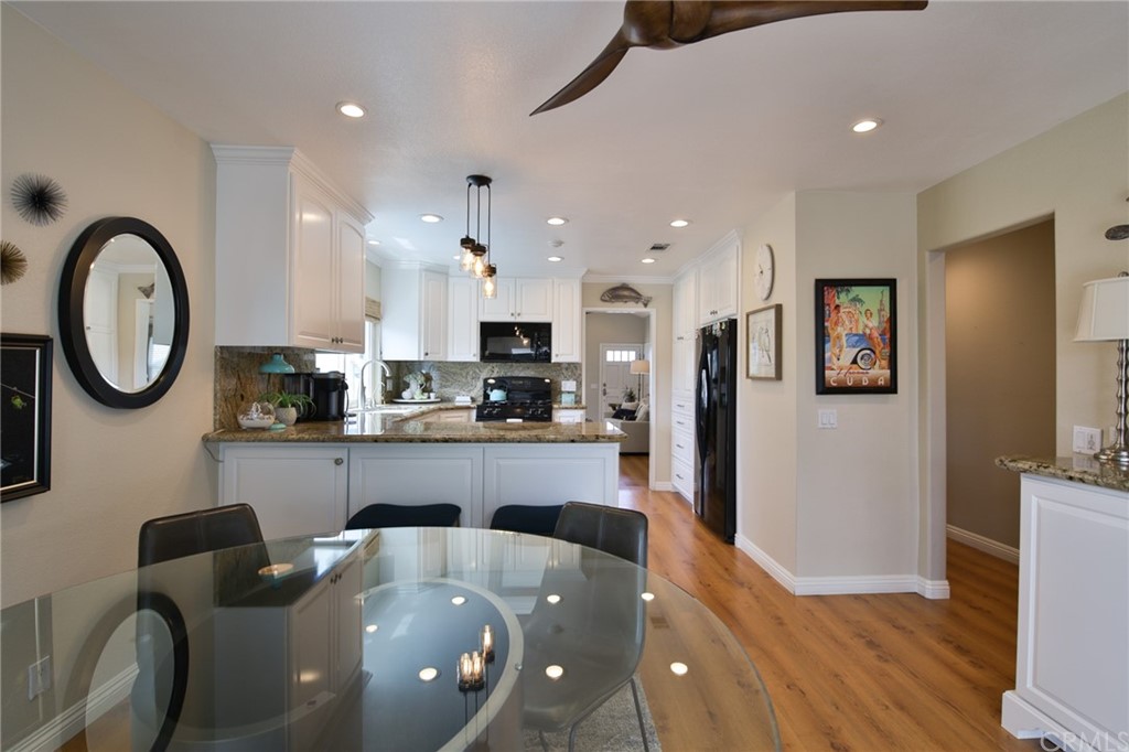 38 Racing Wind Irvine, CA 92614 - Photo 30 of 56 a large kitchen with stainless steel appliances granite countertop a living room and a stove