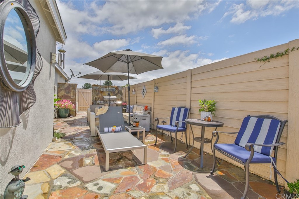 38 Racing Wind Irvine, CA 92614 - Photo 39 of 56 a patio with a patio table and chairs