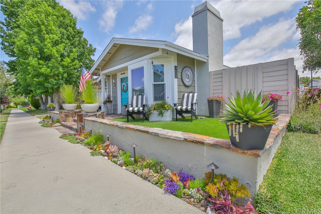 38 Racing Wind Irvine, CA 92614 - Photo 4 of 56 a front view of a house with a yard and a bench