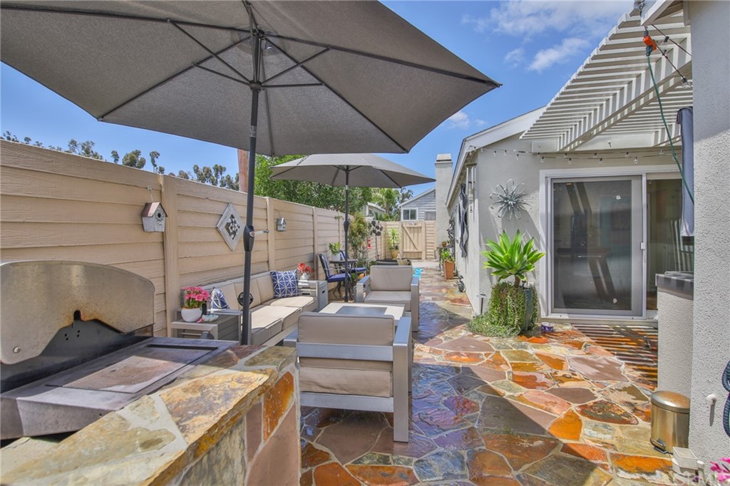 38 Racing Wind Irvine, CA 92614 - Photo 41 of 56 a view of a patio with table and chairs under an umbrella