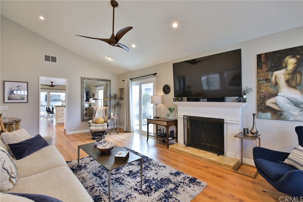 38 Racing Wind Irvine, CA 92614 - Photo 9 of 56 a living room with furniture a flat screen tv and a fireplace