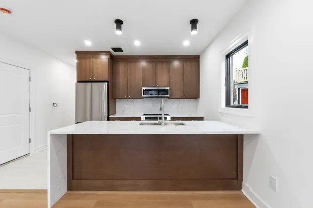 a kitchen with stainless steel appliances a microwave and stove