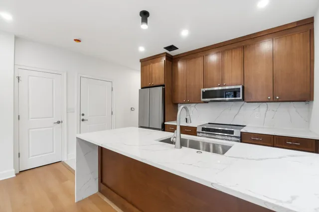 a kitchen with wooden cabinets and a stove top oven