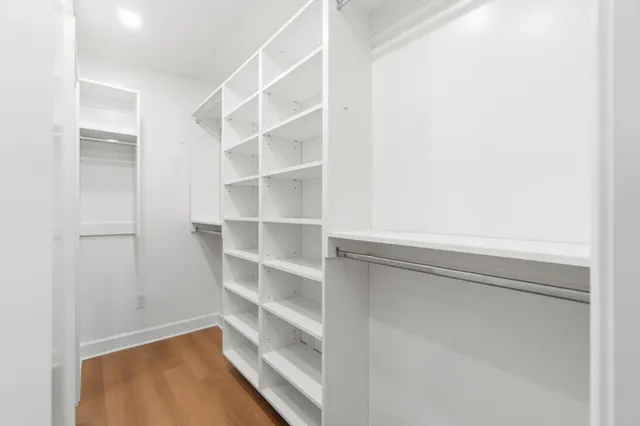 a view of walk in closet with empty racks