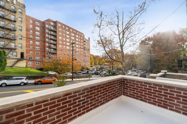 a view of a city street lined with buildings and cars