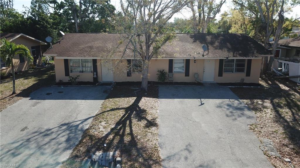 4538 Boabadilla Street Naples, FL 34103 - Photo 2 of 4 a view of a house with a yard covered with snow in the background