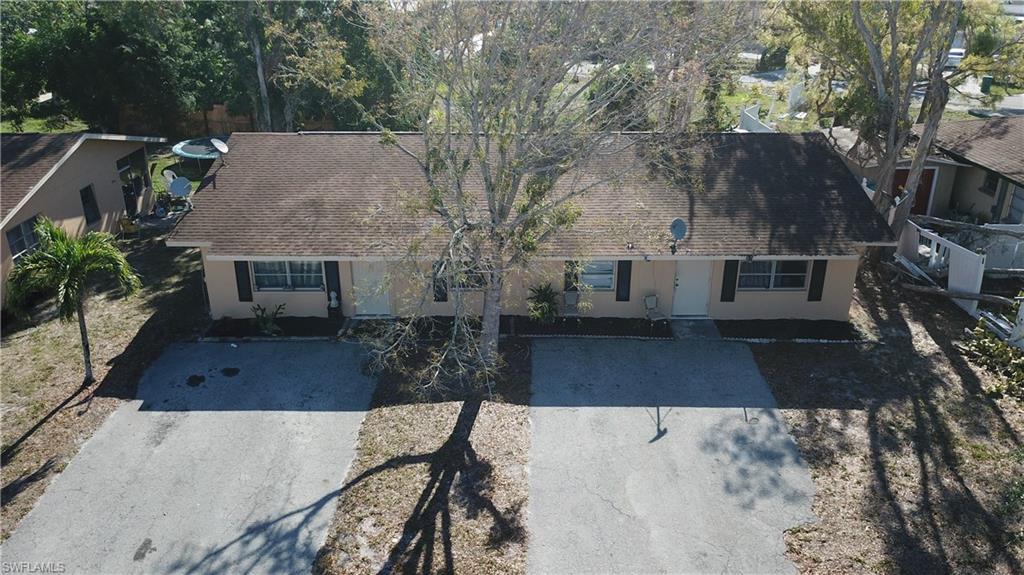 4538 Boabadilla Street Naples, FL 34103 - Photo 3 of 4 a view of a backyard with furniture and tree