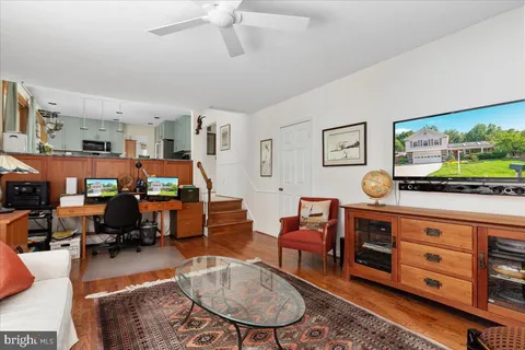 a view of a workspace with furniture and a kitchen