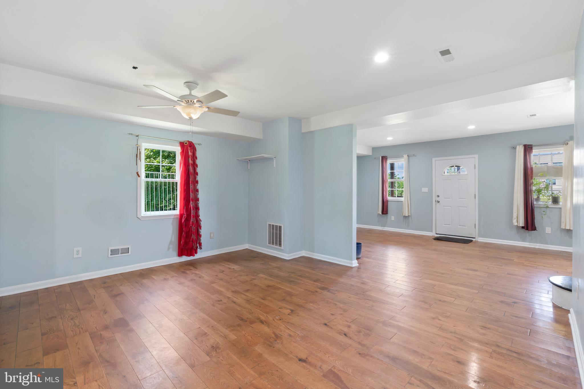 4400 6th Street Baltimore, MD 21225 - Photo 11 of 45 an empty room with wooden floor and windows