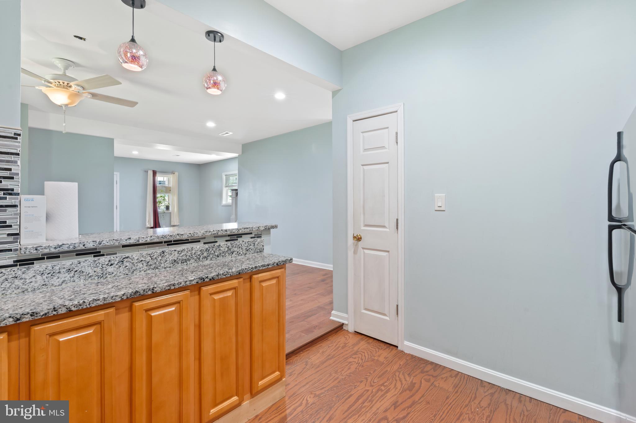 4400 6th Street Baltimore, MD 21225 - Photo 14 of 45 a bathroom with a granite countertop sink and a mirror