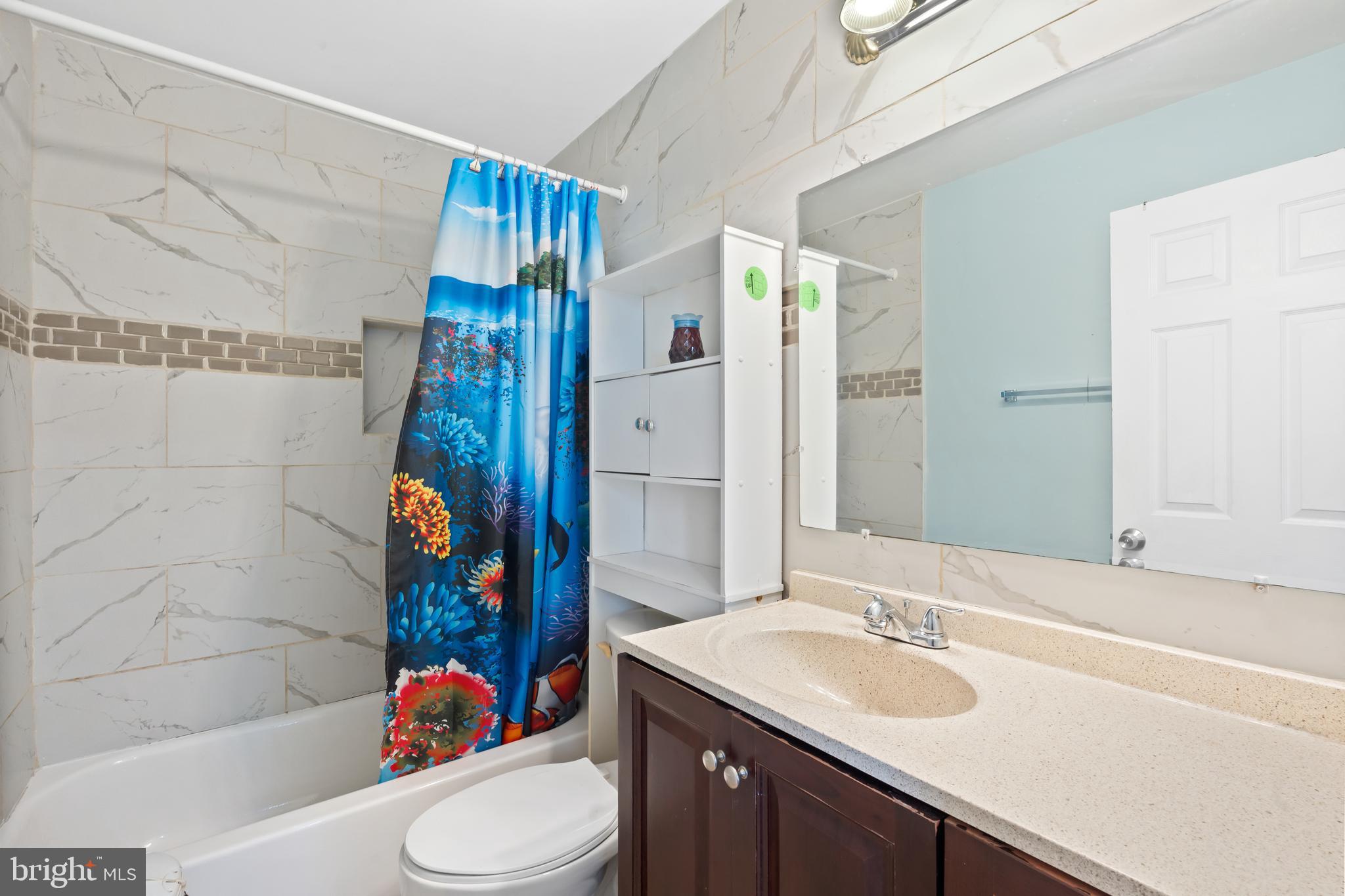 4400 6th Street Baltimore, MD 21225 - Photo 16 of 45 a bathroom with a sink toilet and shower