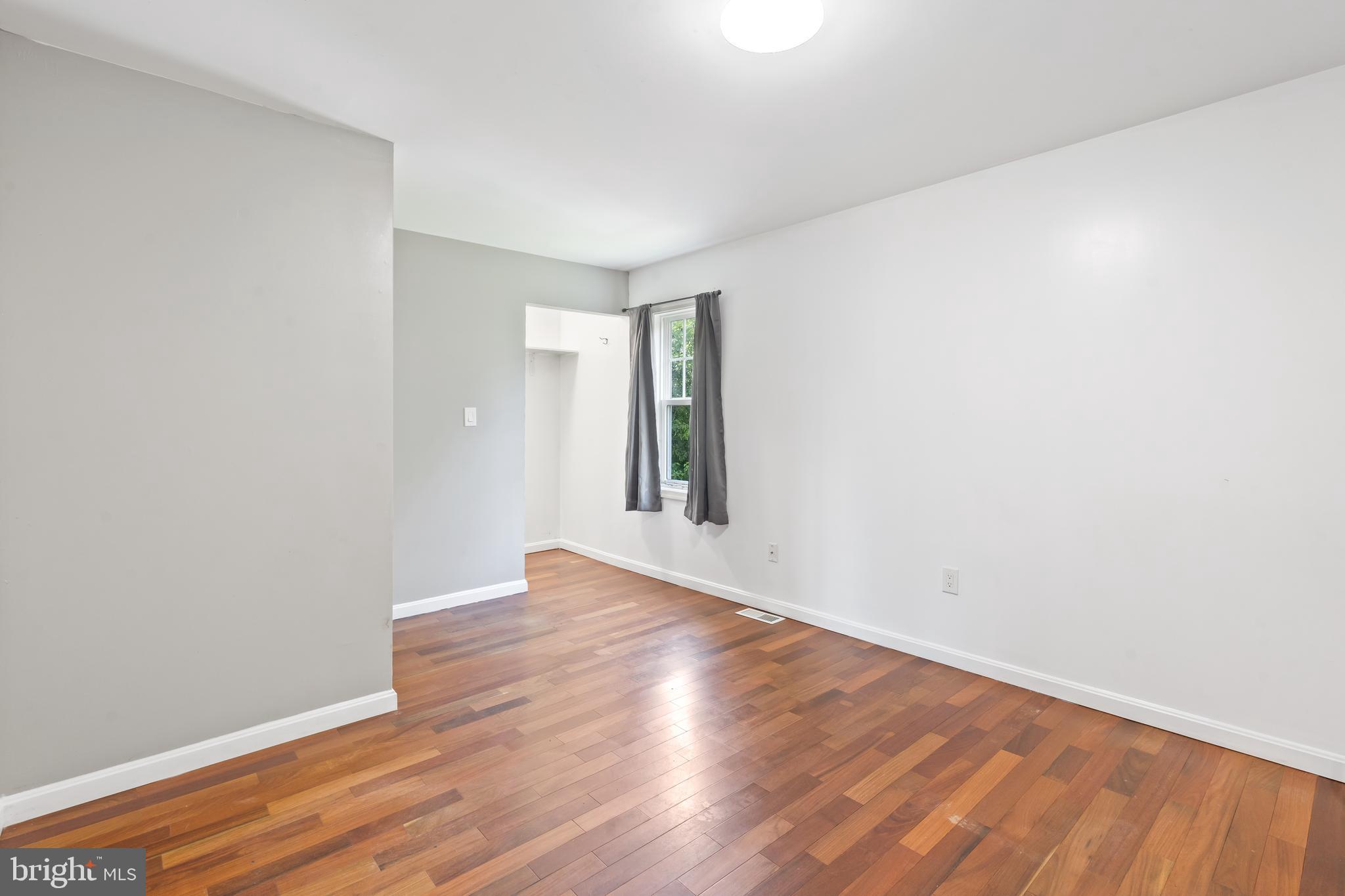 4400 6th Street Baltimore, MD 21225 - Photo 19 of 45 a view of an empty room with wooden floor and a window