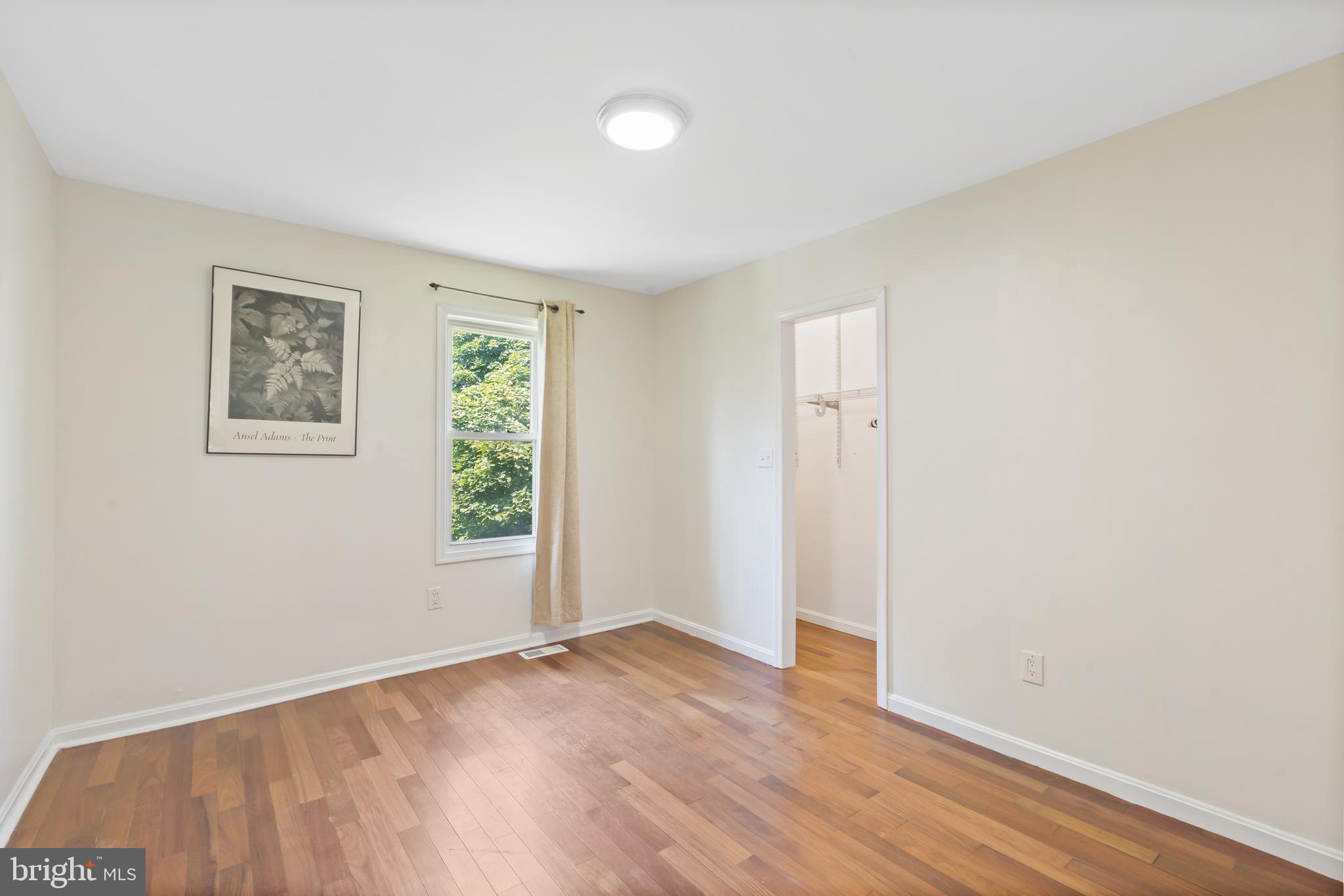 4400 6th Street Baltimore, MD 21225 - Photo 21 of 45 an empty room with wooden floor and windows