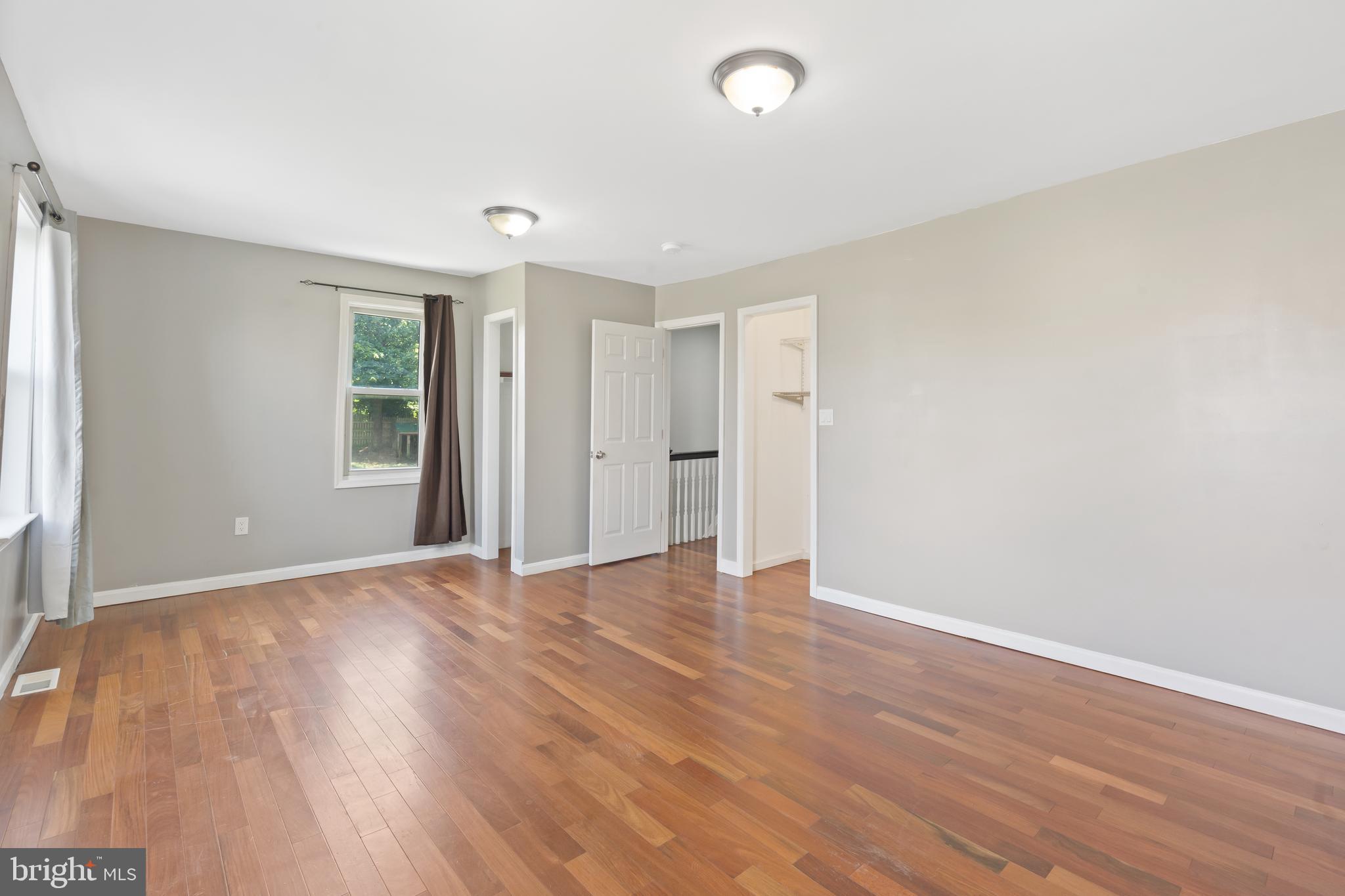 4400 6th Street Baltimore, MD 21225 - Photo 24 of 45 an empty room with wooden floor and windows