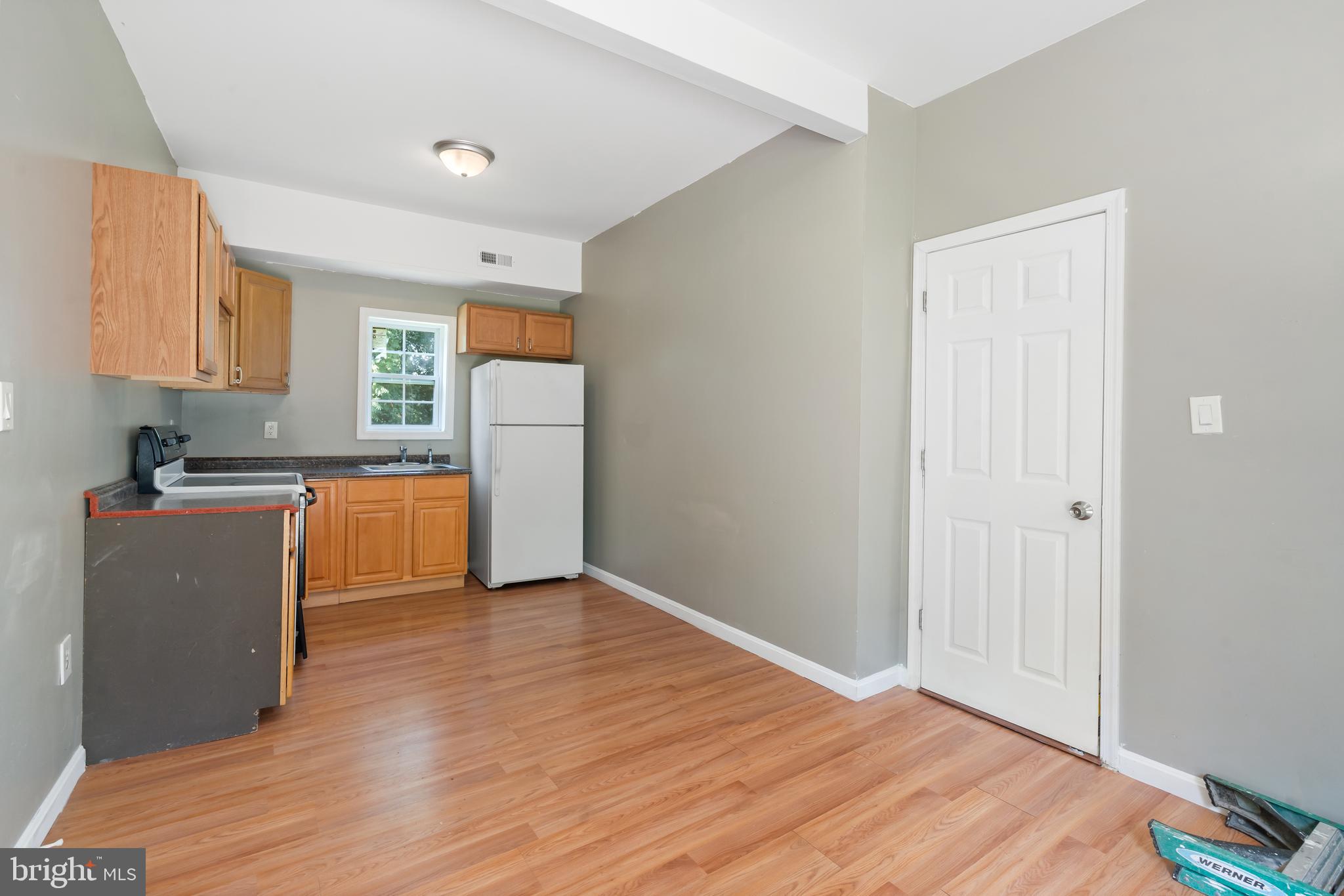 4400 6th Street Baltimore, MD 21225 - Photo 29 of 45 a view of a kitchen with a sink cabinets and wooden floor