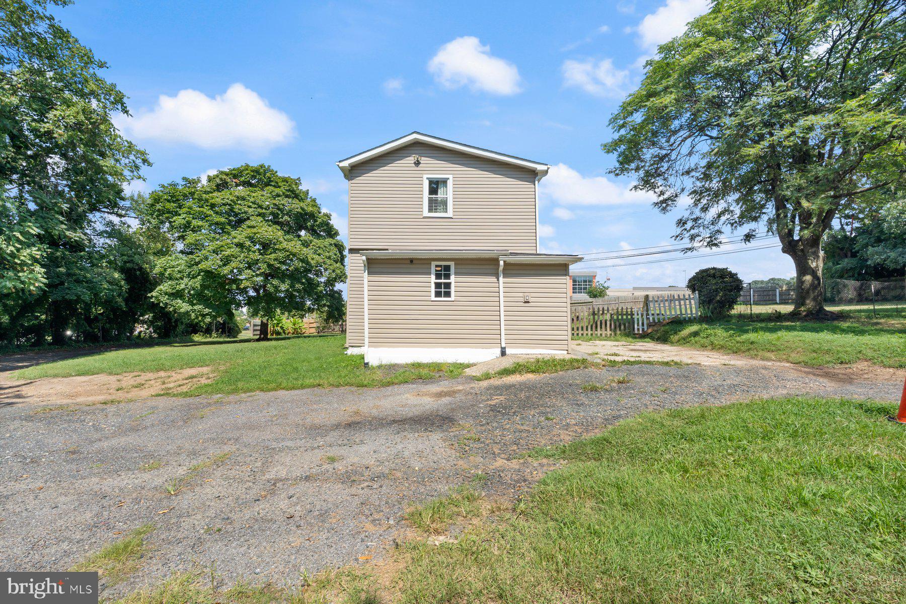 4400 6th Street Baltimore, MD 21225 - Photo 36 of 45 a front view of a house with a yard and garage