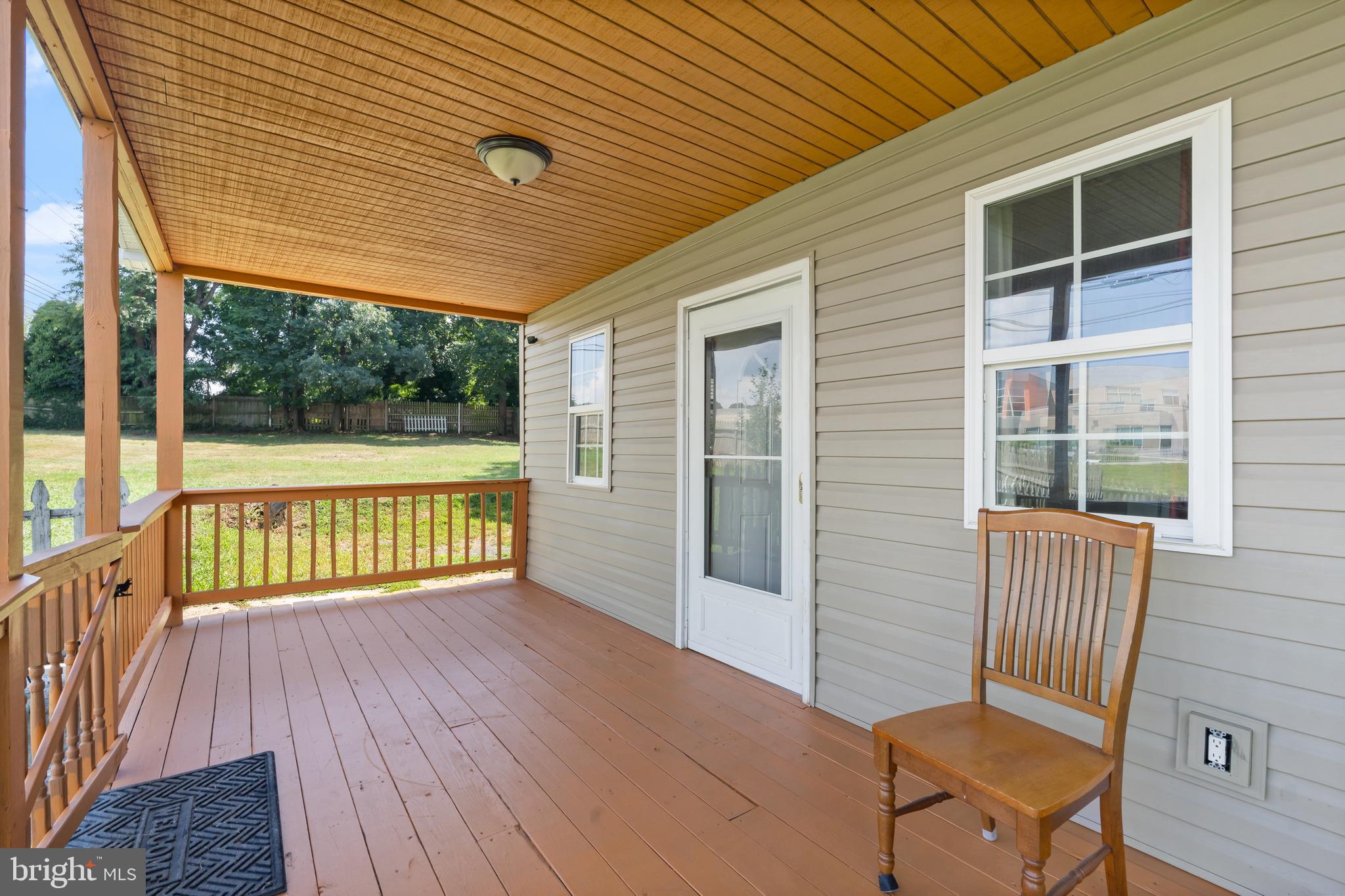 4400 6th Street Baltimore, MD 21225 - Photo 4 of 45 a view of a porch with wooden floor and outdoor seating
