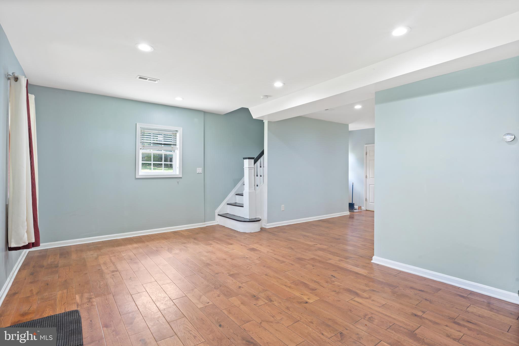 4400 6th Street Baltimore, MD 21225 - Photo 7 of 45 a view of an empty room with wooden floor and a window