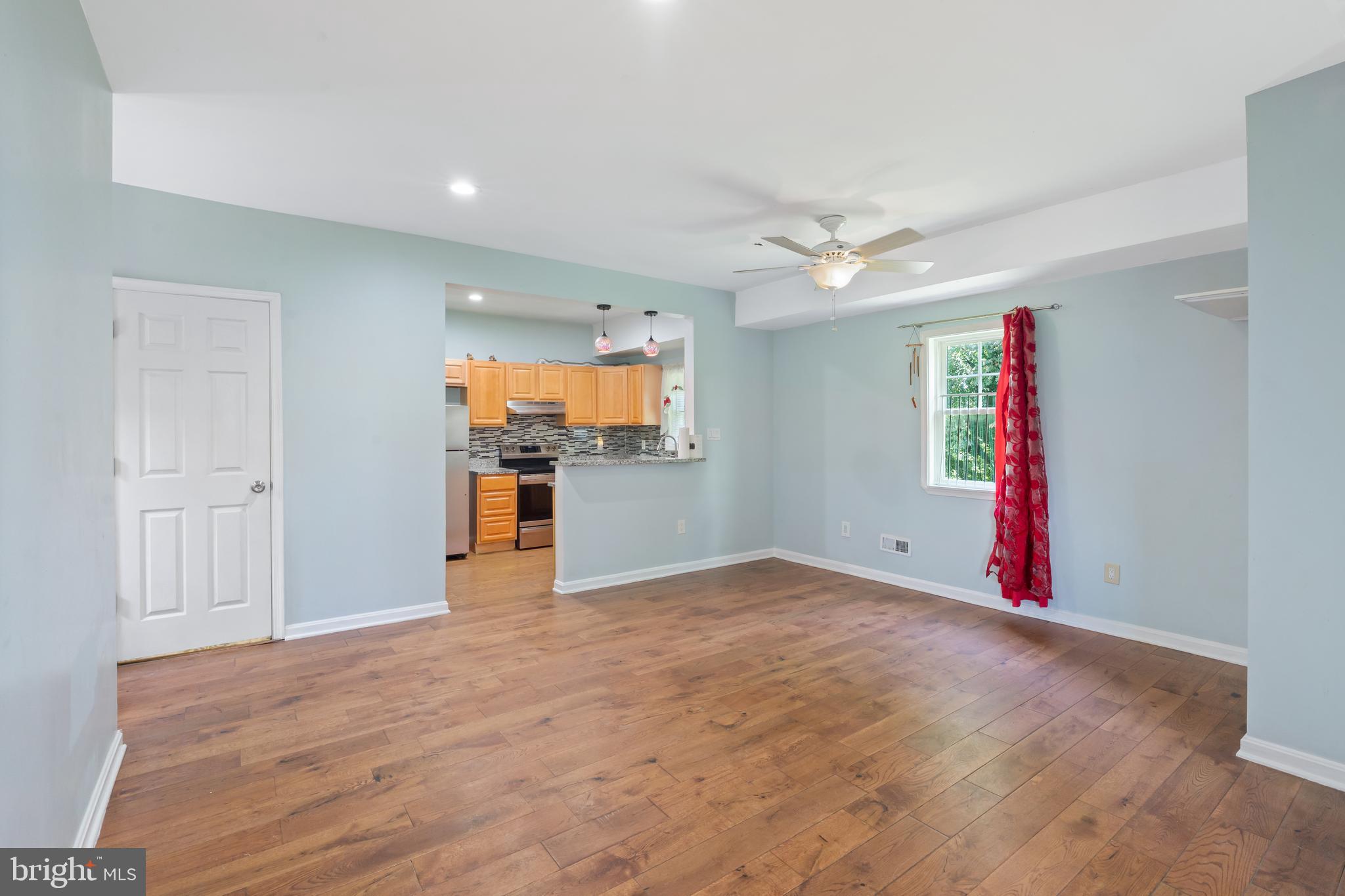 4400 6th Street Baltimore, MD 21225 - Photo 9 of 45 a view of empty room with wooden floor and ceiling fan