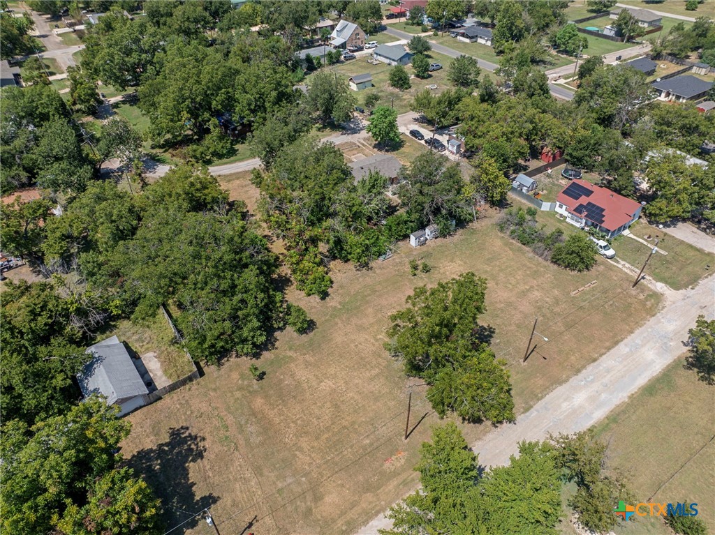 305 South Austin Street Holland, TX 76534 - Photo 1 of 14 an aerial view of a house with a yard and lake view