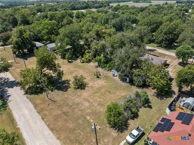 an aerial view of a house with a yard
