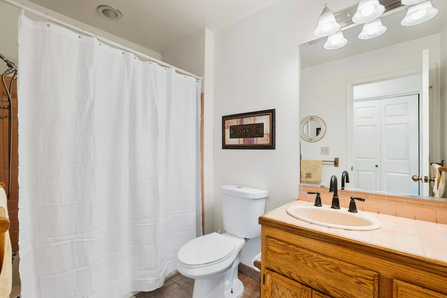 615 Stanley Lane El Sobrante, CA 94803 - Photo 19 of 39 a bathroom with a sink a toilet and mirror