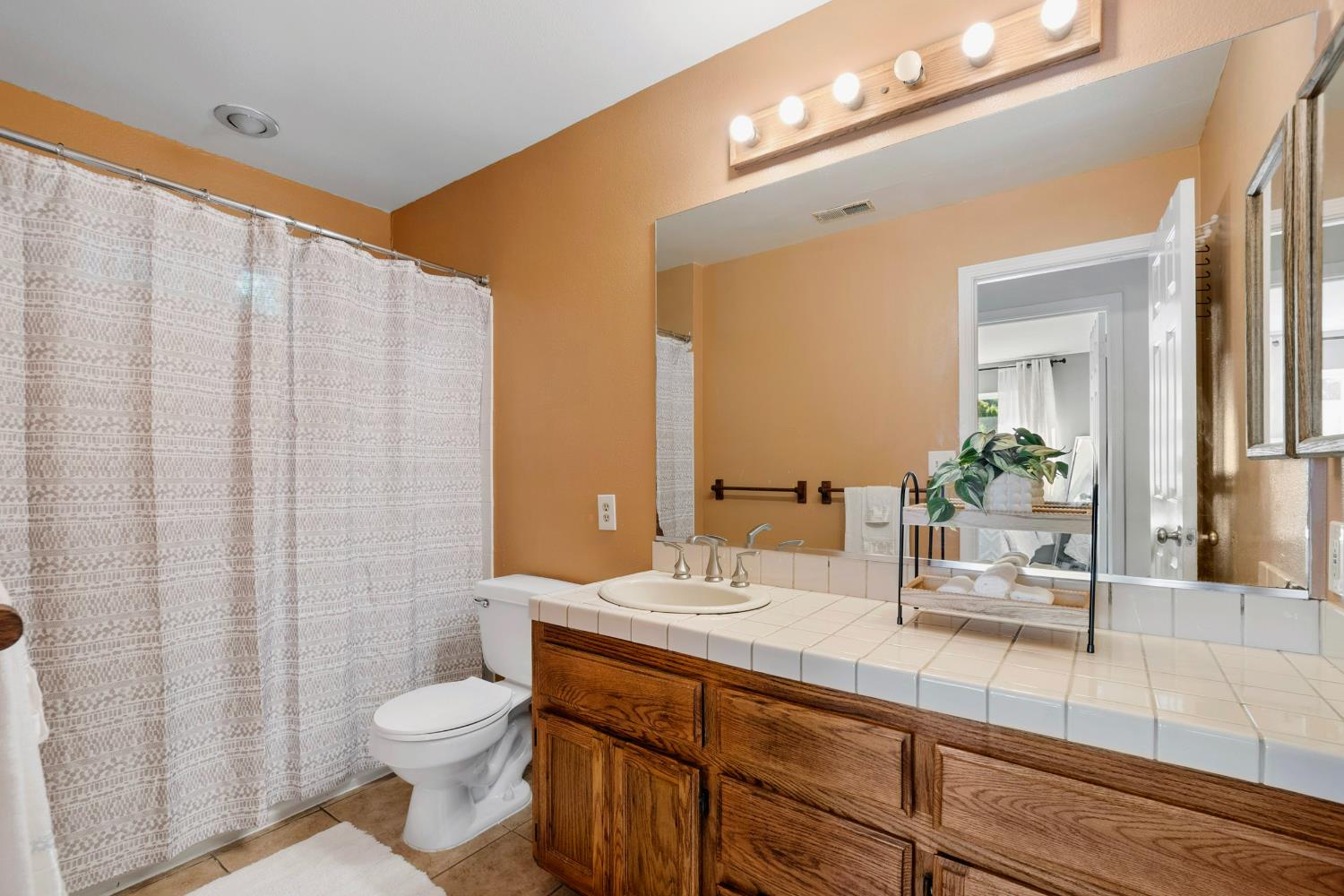 615 Stanley Lane El Sobrante, CA 94803 - Photo 29 of 39 a bathroom with a double vanity sink toilet and a mirror