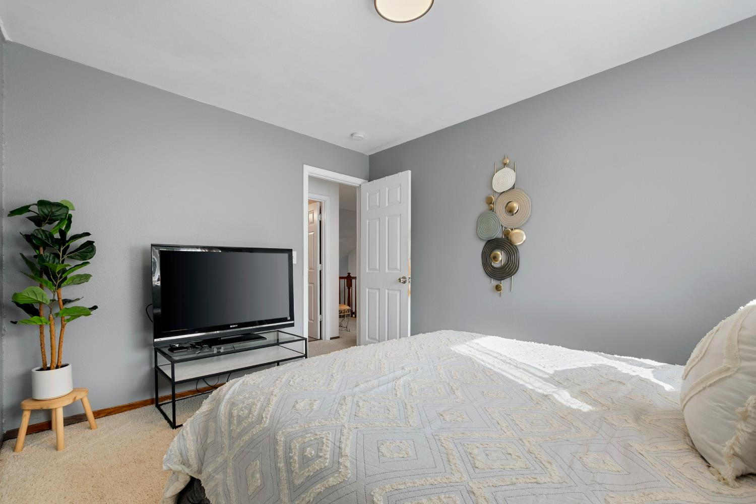 615 Stanley Lane El Sobrante, CA 94803 - Photo 31 of 39 a bedroom with a flat screen tv and a potted plant