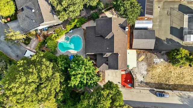 an aerial view of a house with a yard and garden
