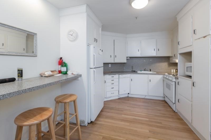 a kitchen with granite countertop a sink cabinets and window