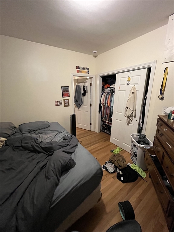 290 Commonwealth Avenue, Unit A Boston, MA 02115 - Photo 20 of 21 a bedroom with a bed and wooden floor