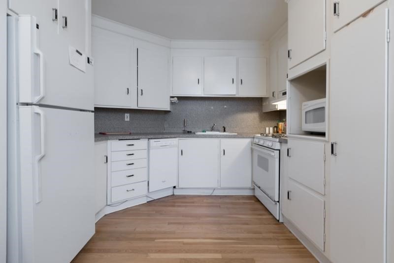 290 Commonwealth Avenue, Unit A Boston, MA 02115 - Photo 3 of 21 a kitchen with white cabinets and white appliances
