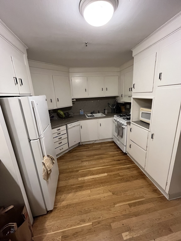 290 Commonwealth Avenue, Unit A Boston, MA 02115 - Photo 5 of 21 a kitchen with white cabinets and white appliances