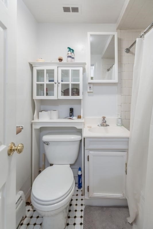 290 Commonwealth Avenue, Unit A Boston, MA 02115 - Photo 10 of 21 a bathroom with a sink toilet and a mirror