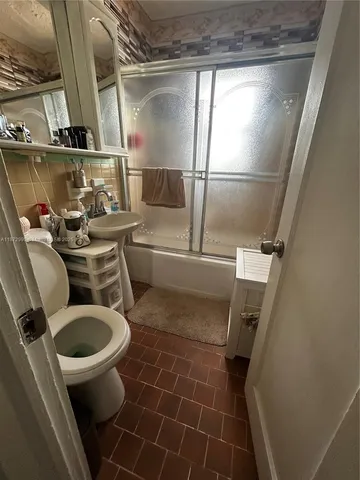 a bathroom with a sink and toilet