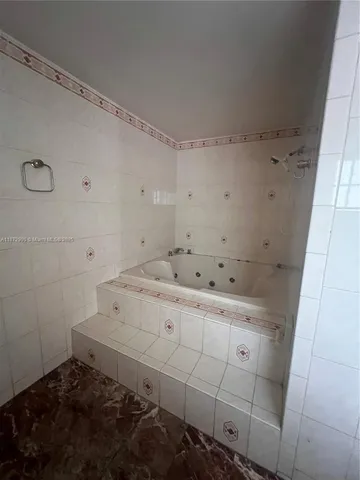 a view of an empty room with a fireplace