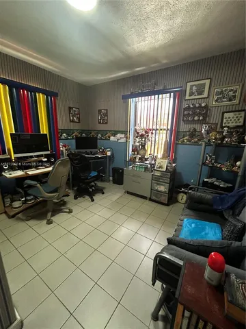 a living room with furniture a flat screen tv and a window