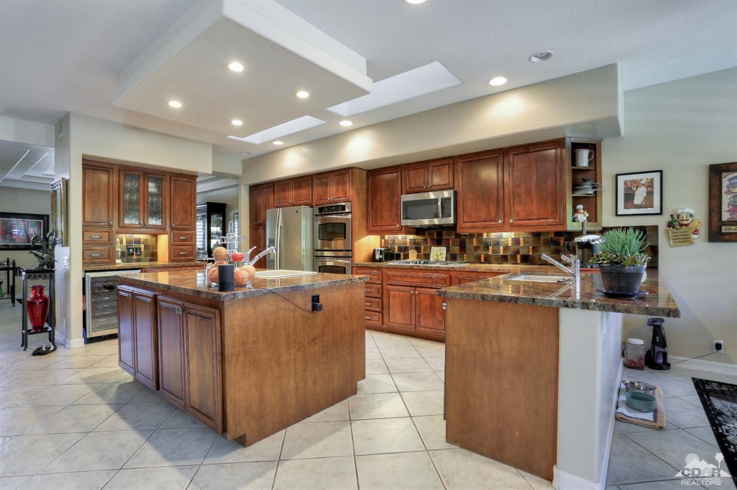 a kitchen with stainless steel appliances granite countertop a refrigerator and a stove